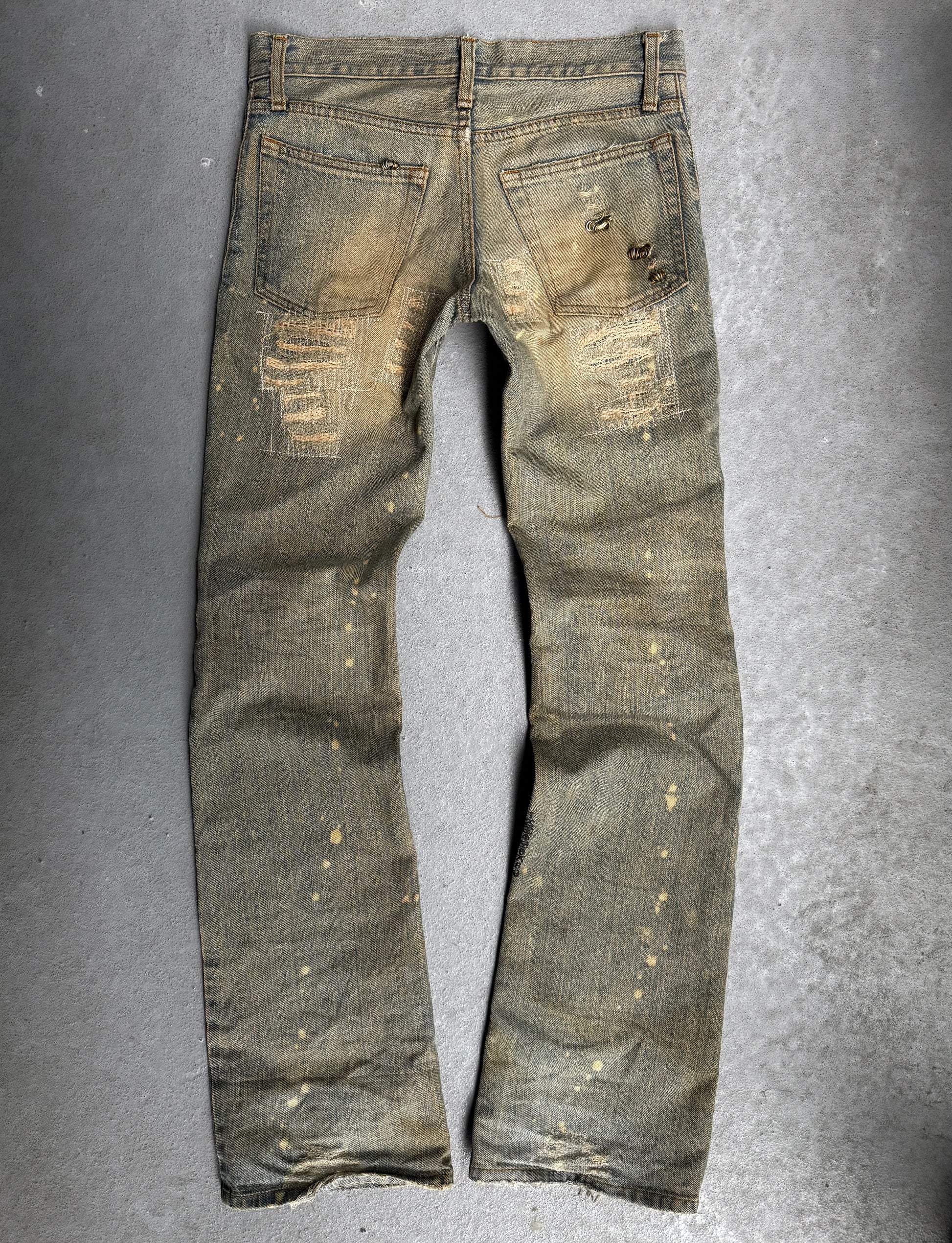 Worn denim jeans on a gray background