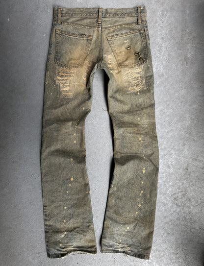 Worn denim jeans on a gray background