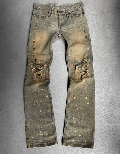 Distressed denim jeans on a gray background