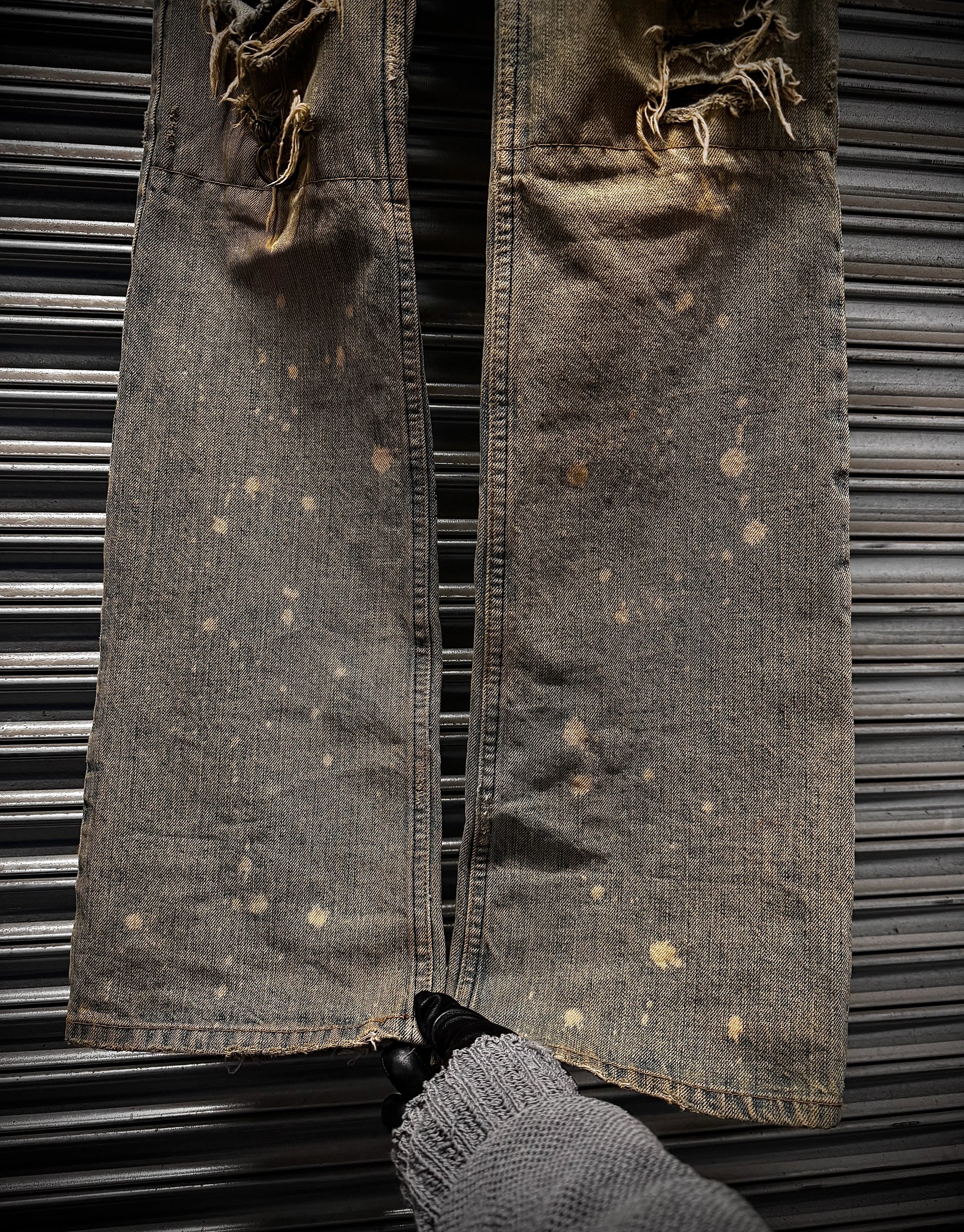 Rusticated denim jacket with a distressed look on a metal background