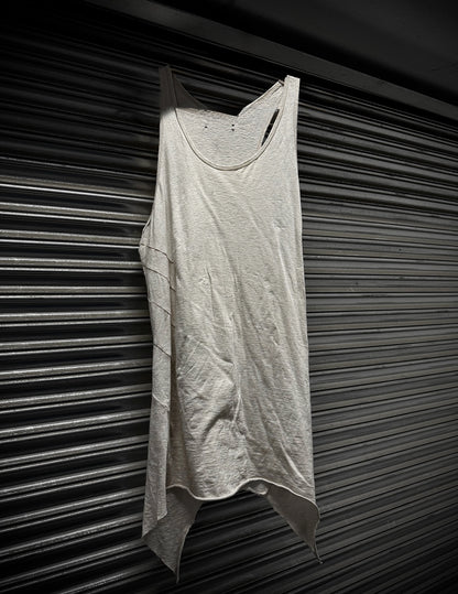 Light gray tank top hanging against a dark, textured wall.