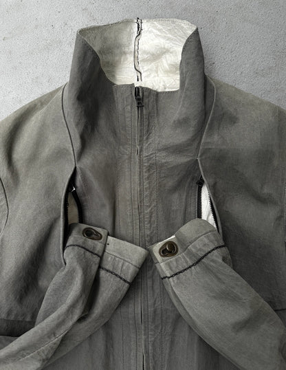 Gray coat with a zipper and button details on a gray background