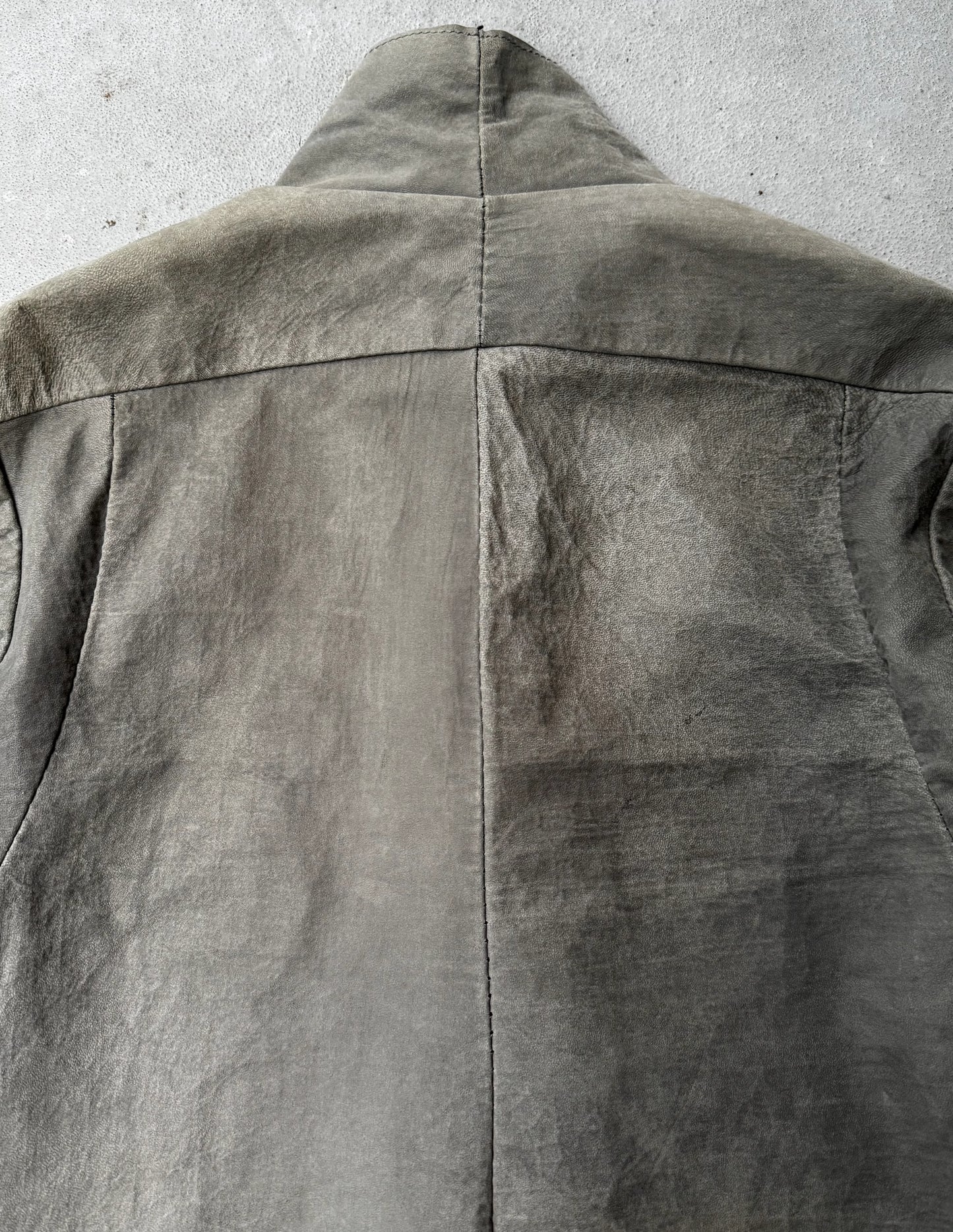 Close-up of a gray jacket on a concrete surface