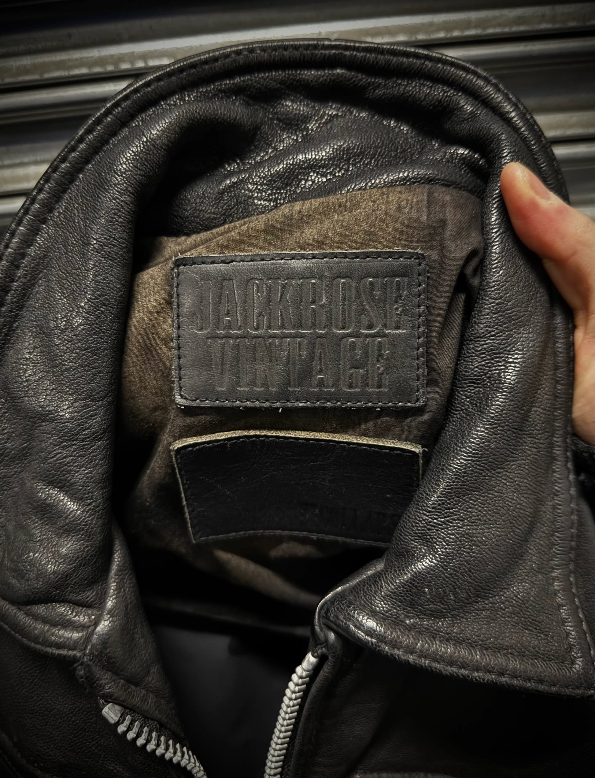 Close-up of a leather jacket with 'Jack Rose Vintage' label.
