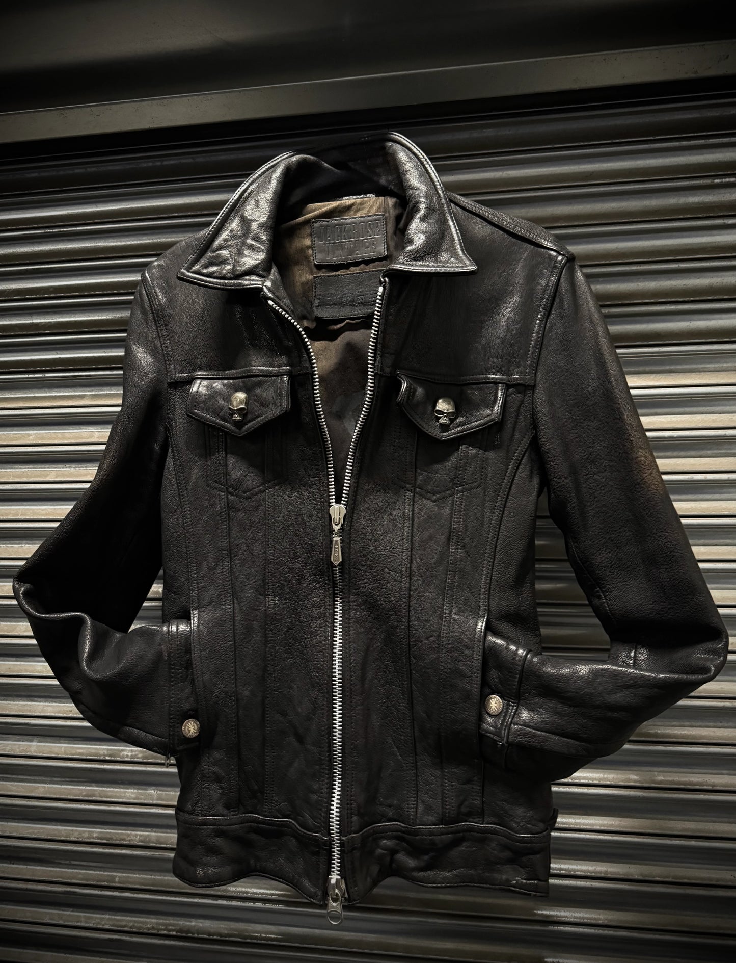 Black leather jacket on a metallic surface