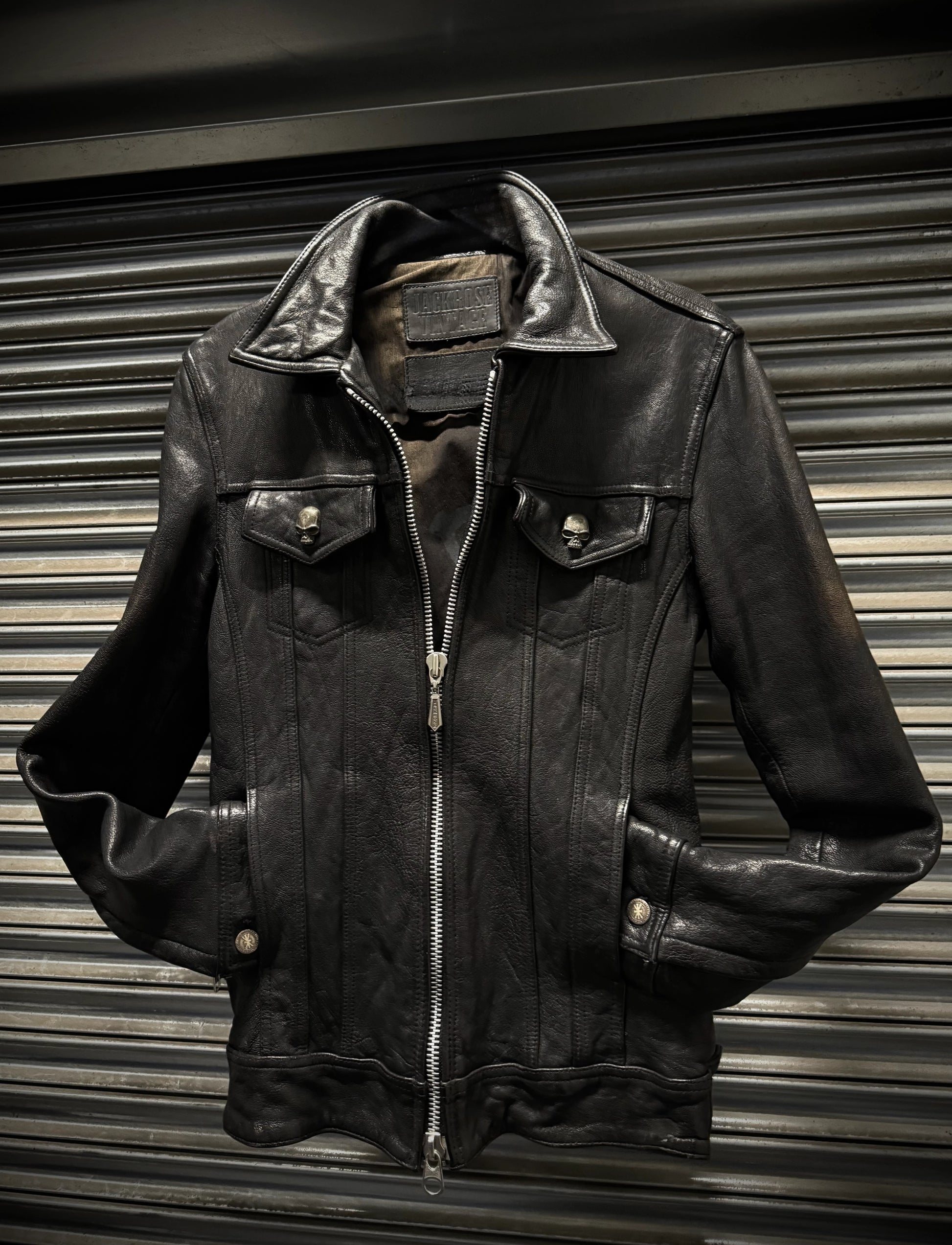 Black leather jacket on a metallic surface