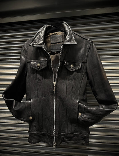 Black leather jacket on a metallic surface