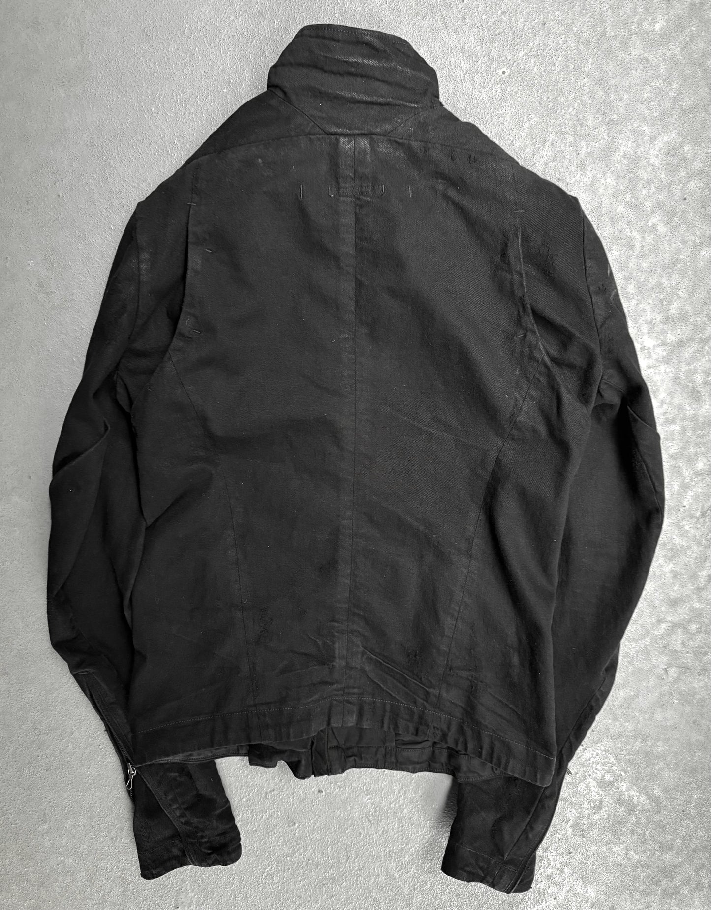 Black jacket on a textured gray surface