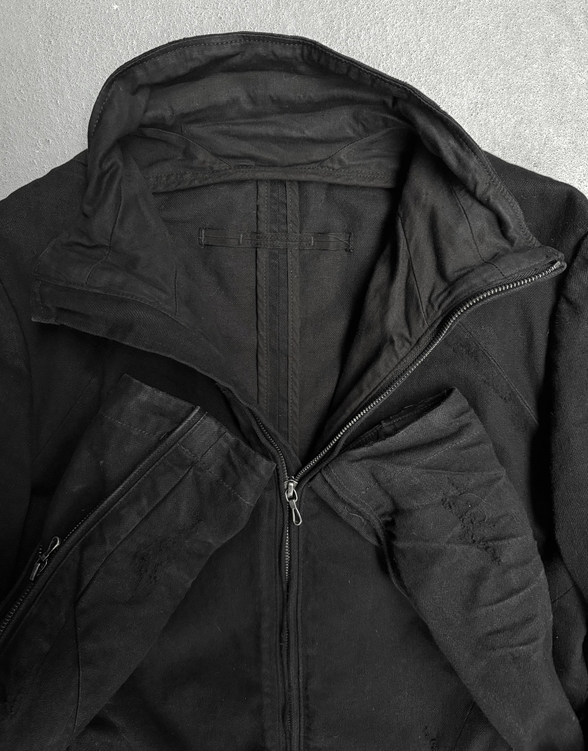 Close-up of a black jacket with a hood on a gray background