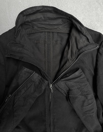 Close-up of a black jacket with a hood on a gray background