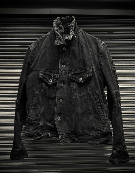 Dark denim jacket with frayed collar on a metallic background