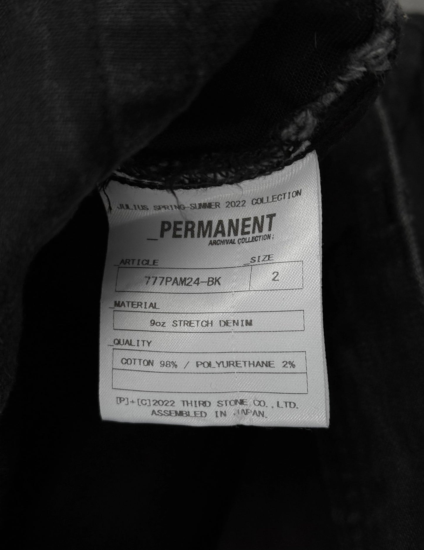 Julius_7 SS22 "_PERMANENT" Washed Black Distressed J-Cut Denim