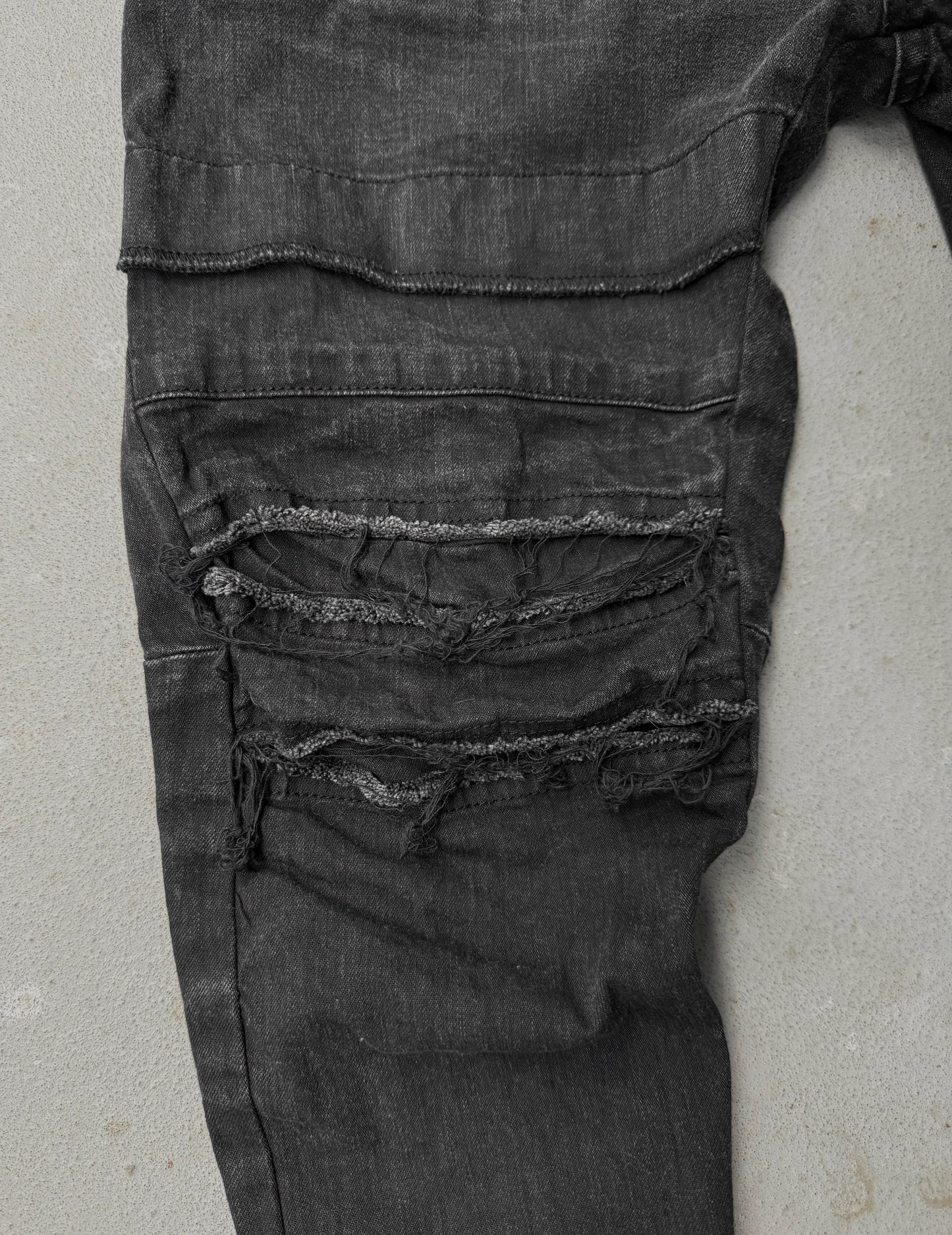 Julius_7 SS22 "_PERMANENT" Washed Black Distressed J-Cut Denim