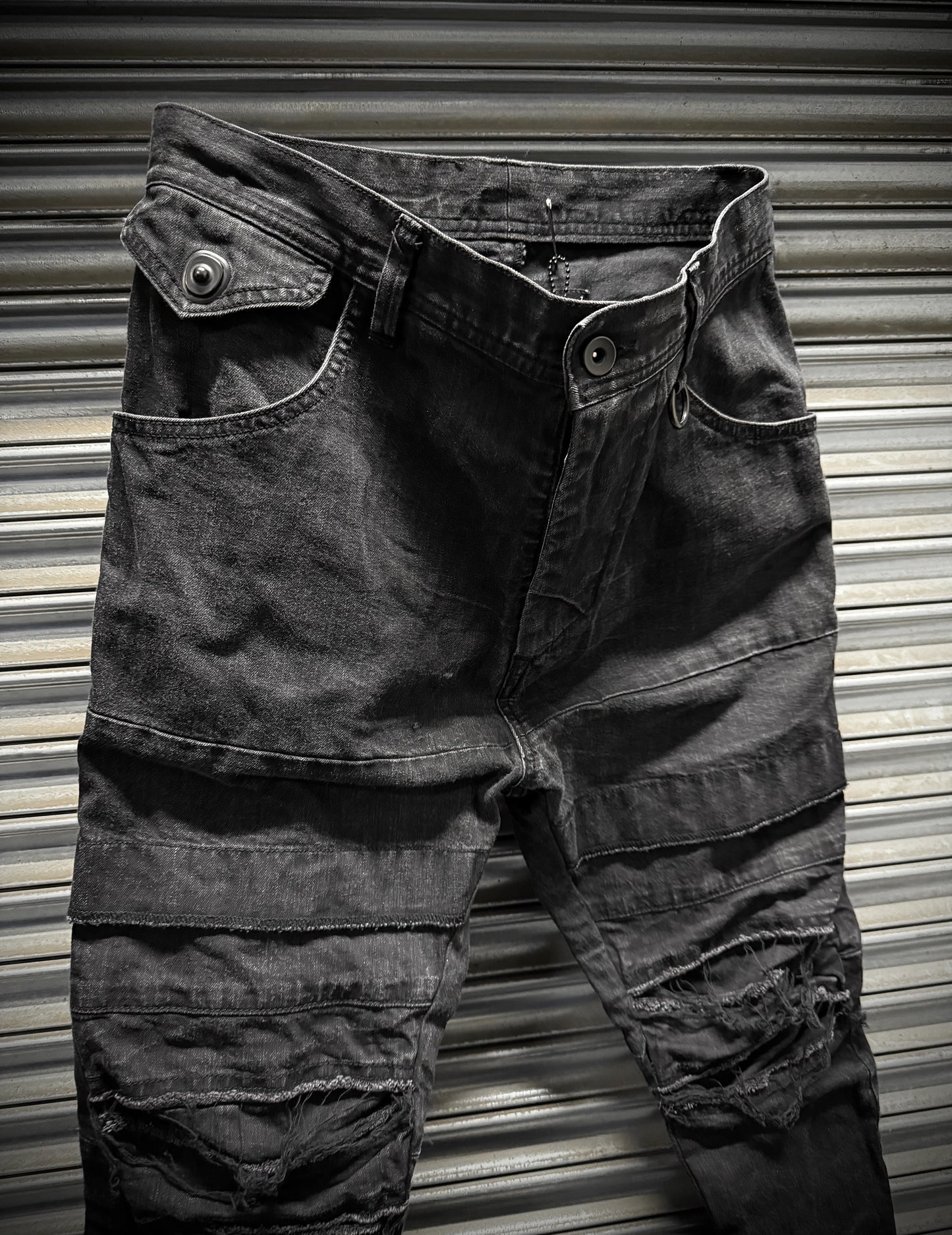 Julius_7 SS22 "_PERMANENT" Washed Black Distressed J-Cut Denim