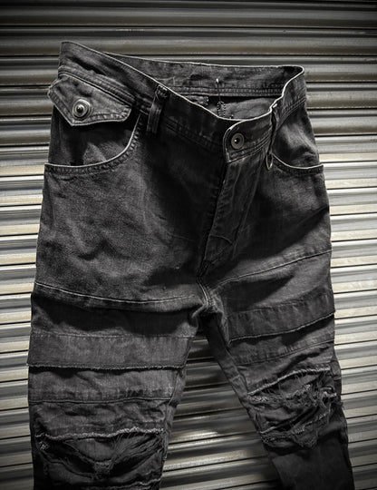 Julius_7 SS22 "_PERMANENT" Washed Black Distressed J-Cut Denim
