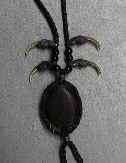 Necklace with claw-like pendants on a gray background