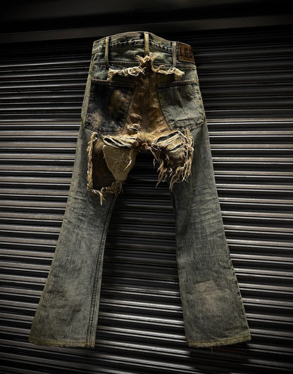 Rustic, distressed denim jeans against a metallic background