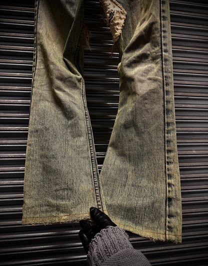 Pair of distressed jeans on a metallic surface
