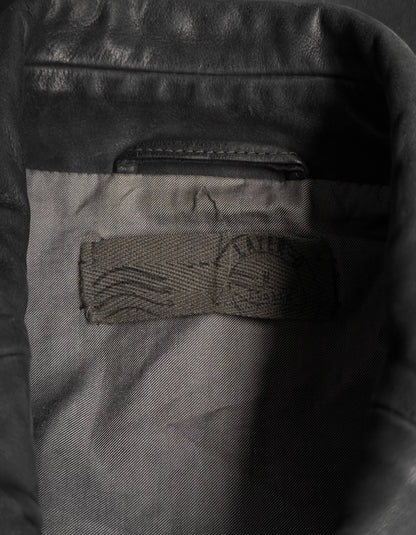 Close-up of a leather jacket with a brand logo on the chest pocket.
