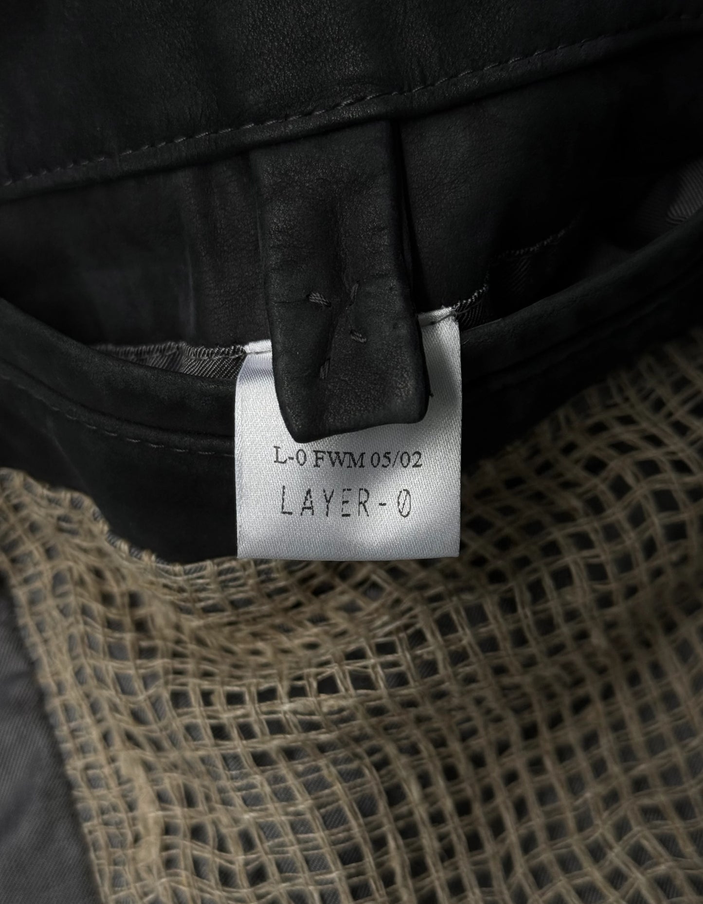 Close-up of a label on a piece of clothing with text and design details.