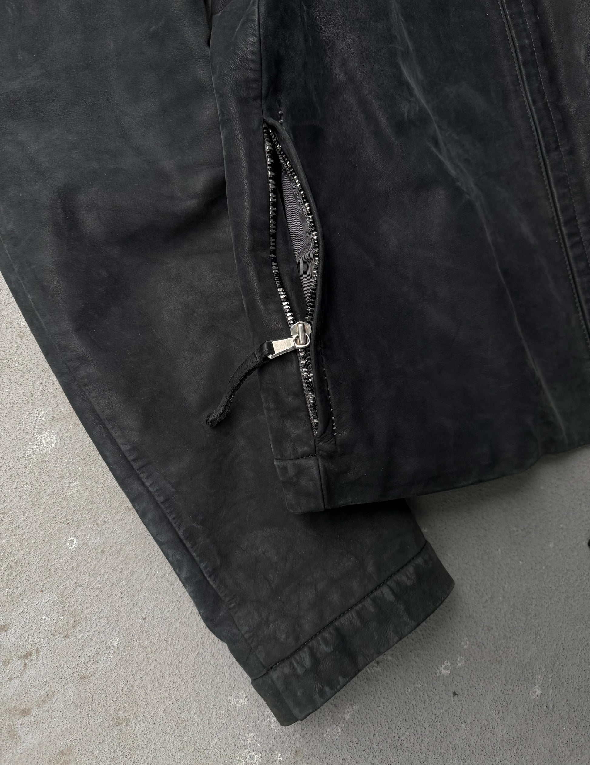 Close-up of a black jacket with a zipper on a gray surface