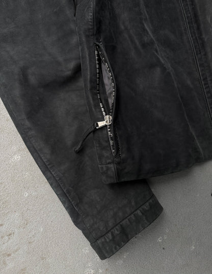 Close-up of a black jacket with a zipper on a gray surface