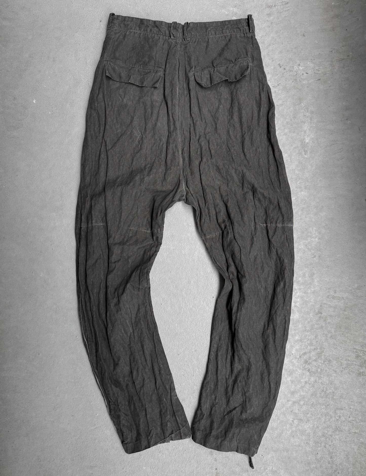 Dark gray pants on a flat surface