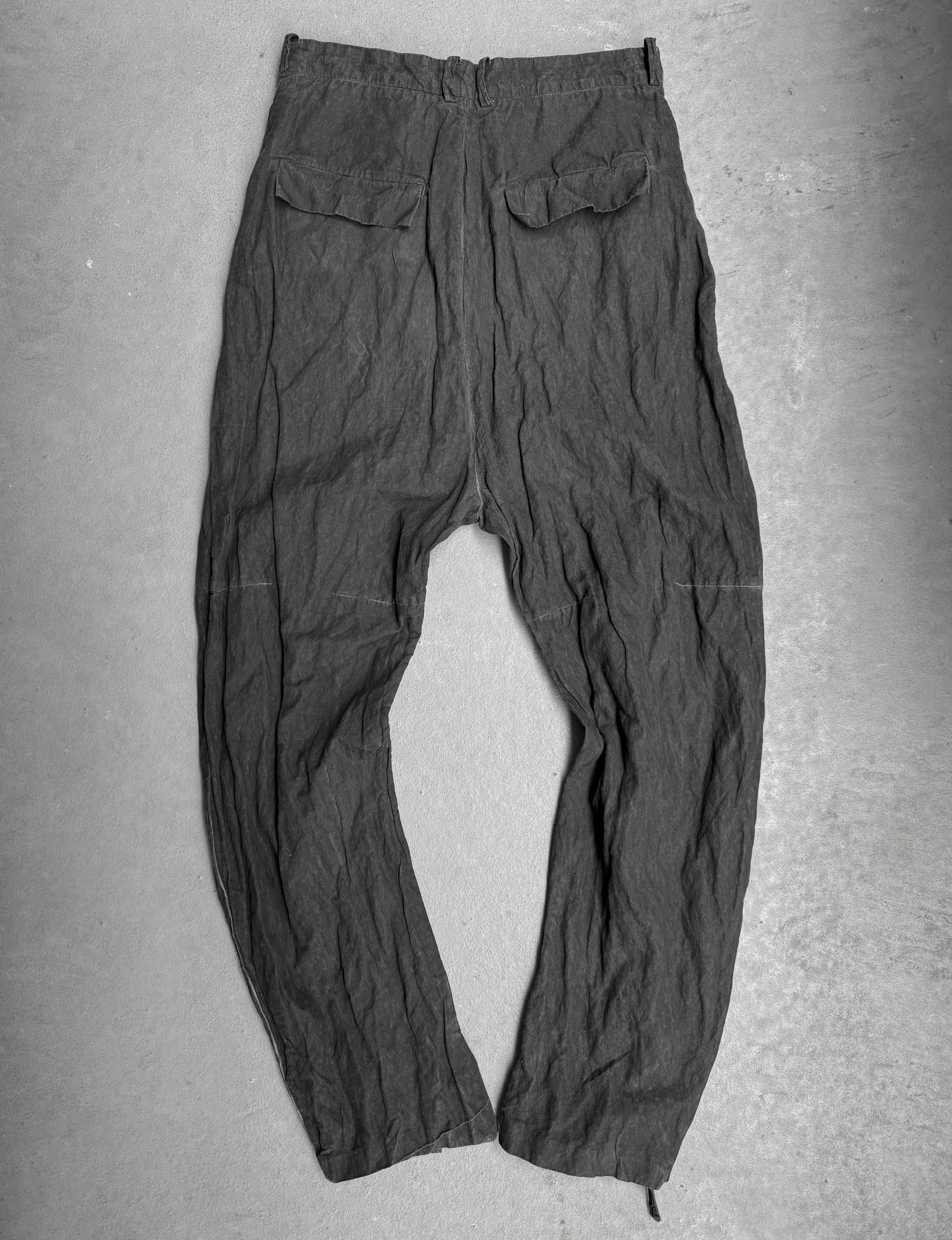 Dark gray pants on a flat surface