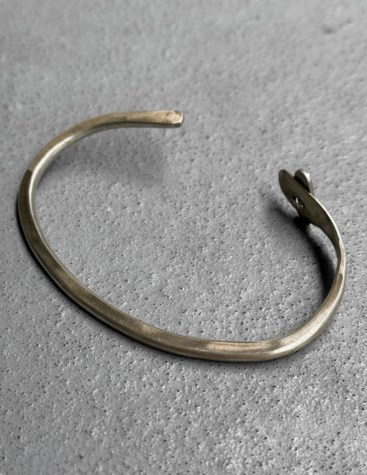 Silver bracelet on a textured gray surface
