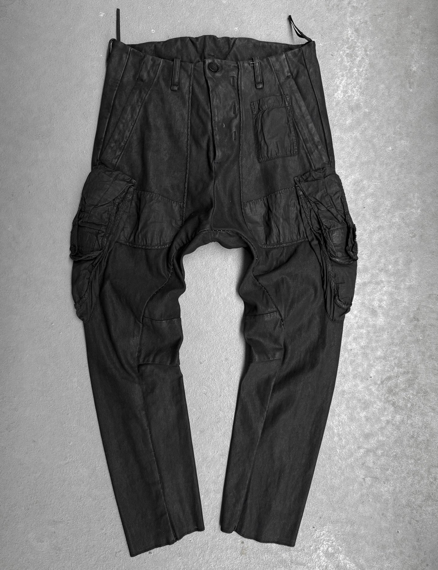 Black cargo pants on a gray textured background