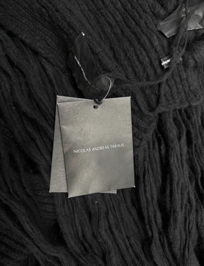 Dark textured fabric with a brand tag on a black background