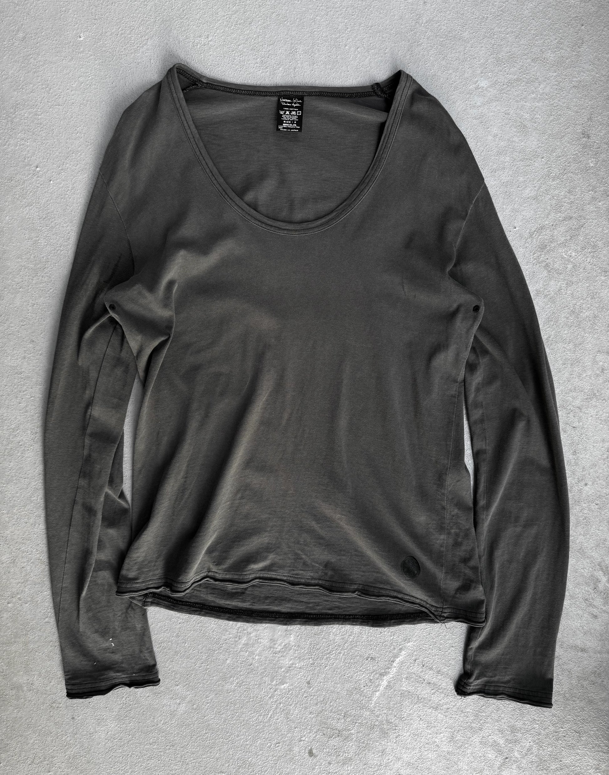 Dark gray long-sleeve shirt on a textured gray surface