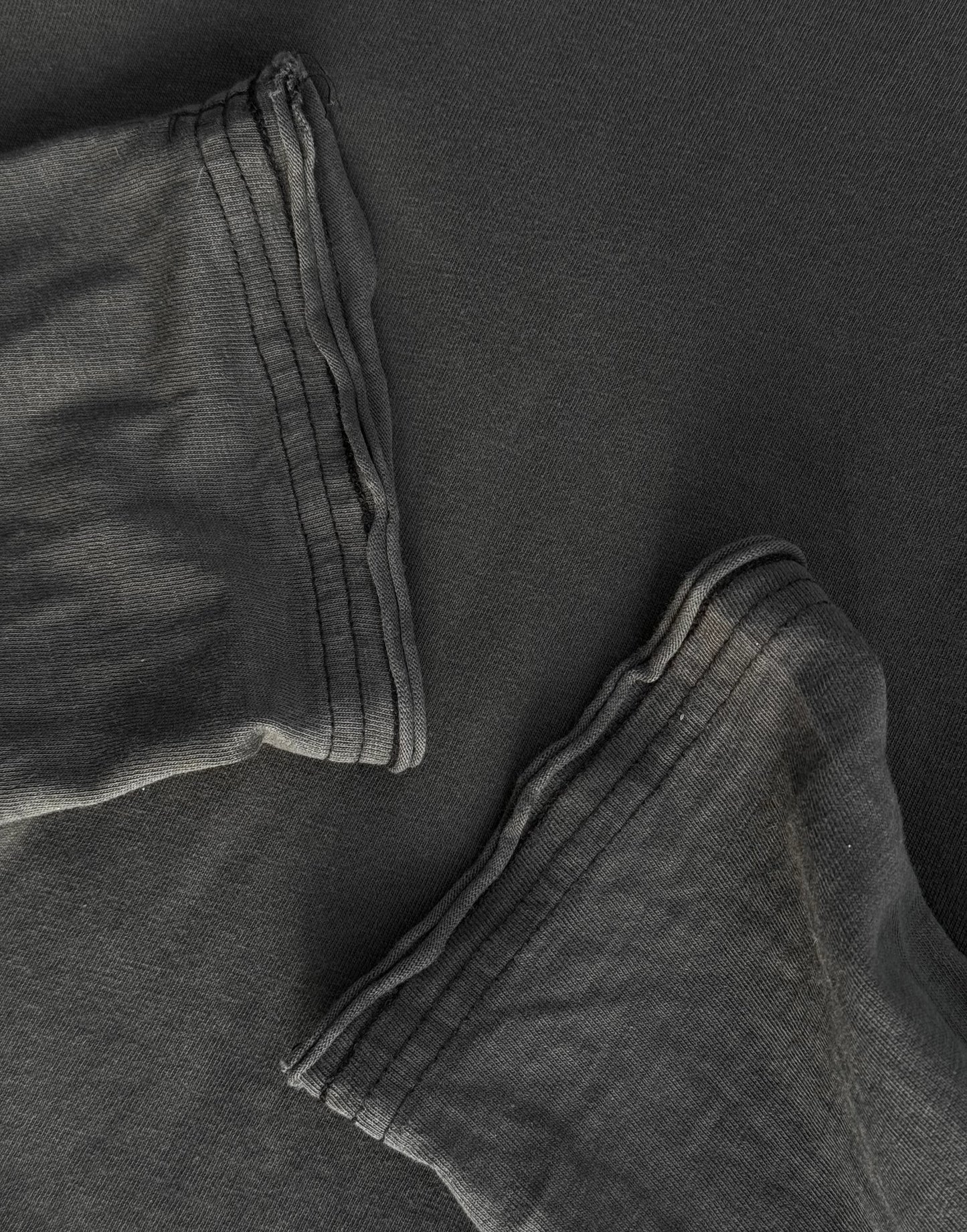 Close-up of dark gray pants with a focus on texture and folds.
