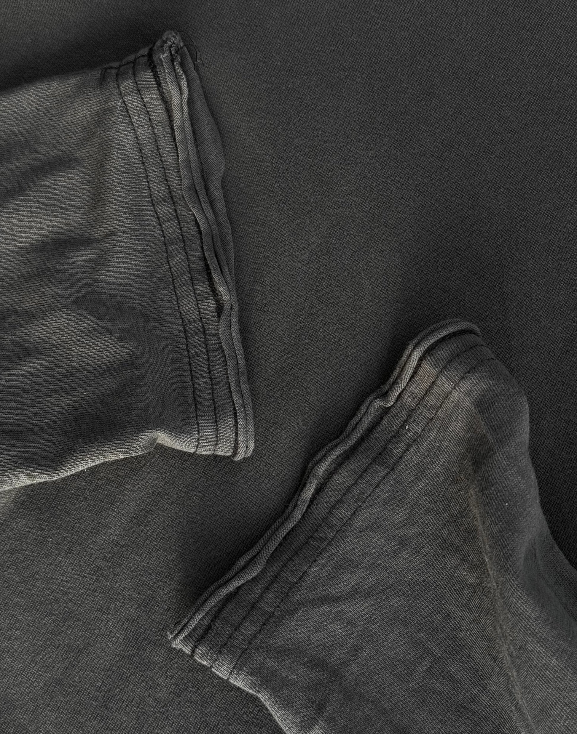 Close-up of dark gray pants with a focus on texture and folds.