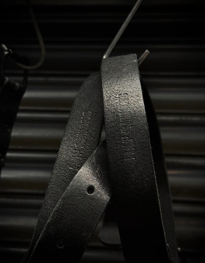 Close-up of a black metal object with text on a dark background