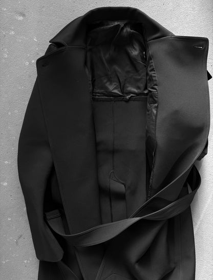 Black coat on a textured gray background