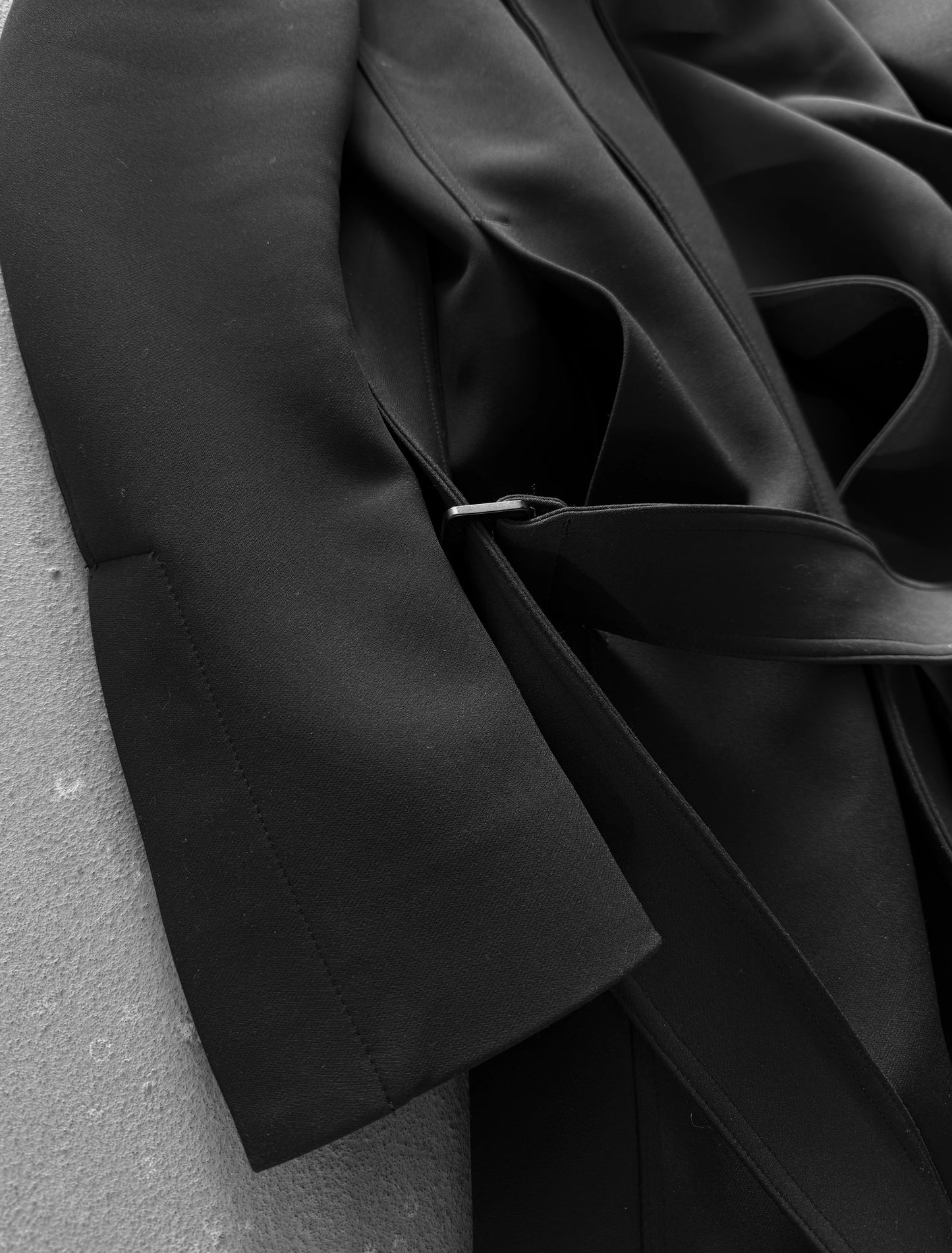 Close-up of a black fabric garment on a gray surface