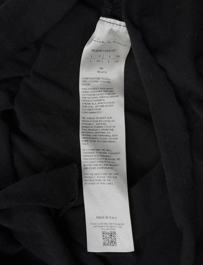 Black fabric with a label detailing material composition and production details.