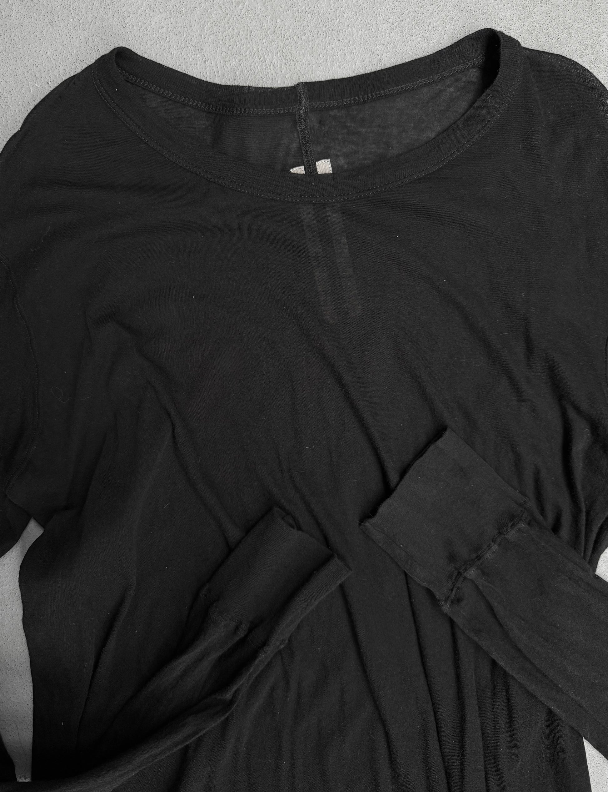 Black long-sleeve top with a collar on a gray background