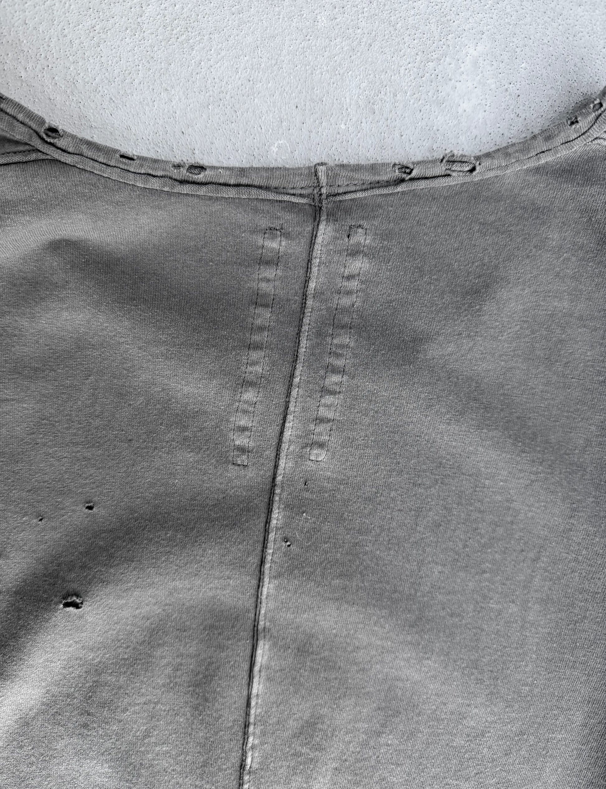 Close-up of a gray fabric with stitching details on a white background