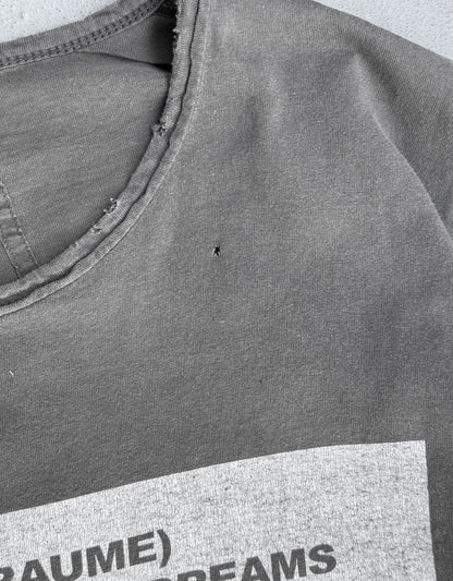 Gray t-shirt with text on a plain background