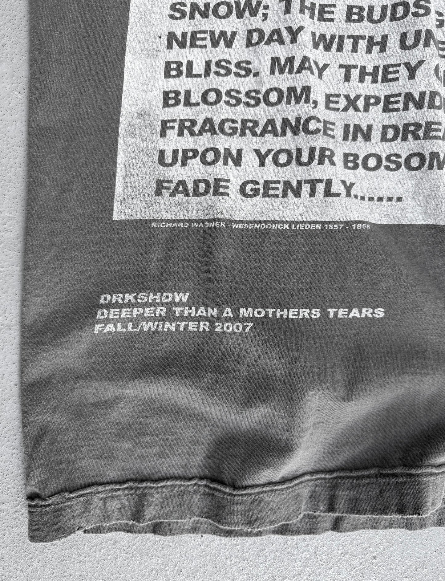 Gray sweatshirt with text and branding on a light gray background