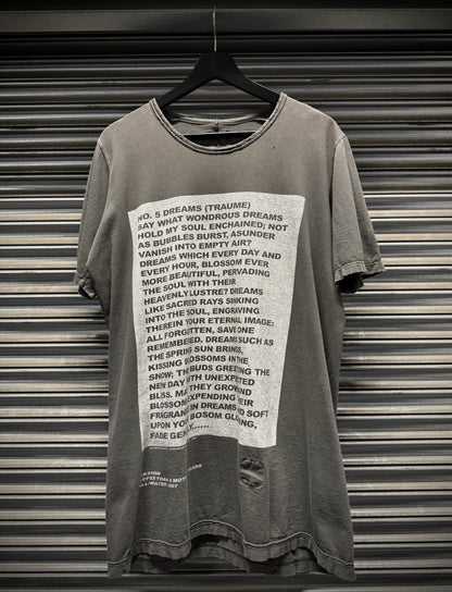 Gray t-shirt with text design on a hanger against a metallic shutter background