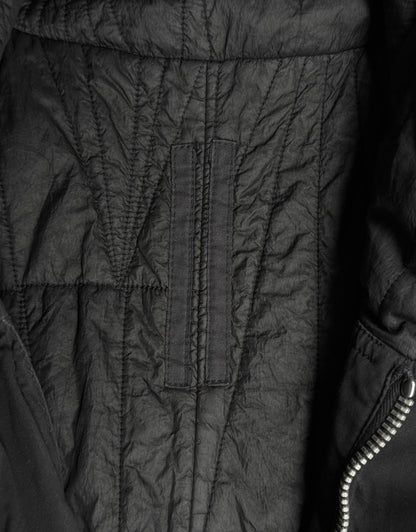 Close-up of a black quilted jacket with visible stitching details.