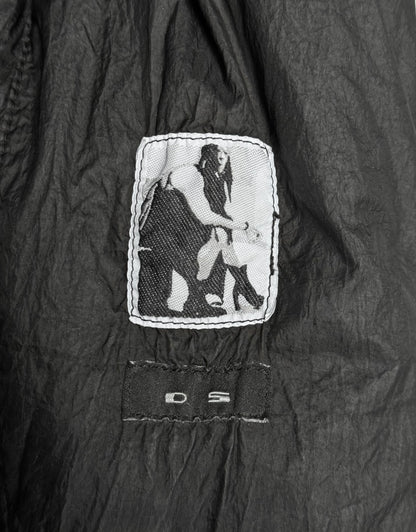 Black jacket with a white logo on a dark background