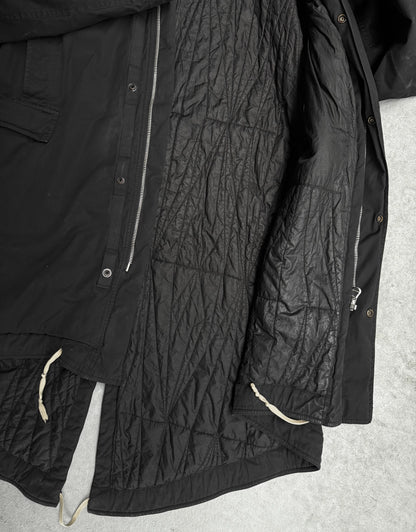 Black quilted jacket on a light gray background