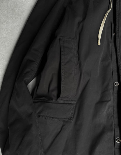 Close-up of a black jacket with a pocket and zipper detail.