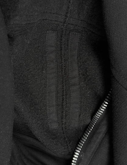 Close-up of a textured black fabric surface with a zipper
