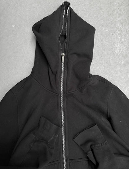 Black hoodie with a zipper on a gray background