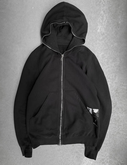 Black hoodie with a zipper on a gray background